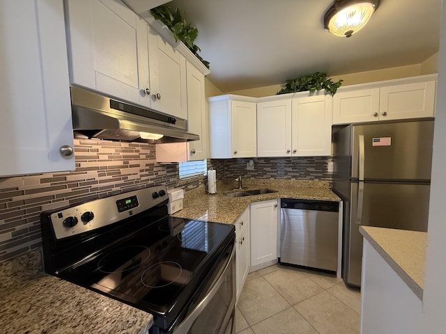 kitchen with sink, light tile patterned floors, stainless steel appliances, light stone countertops, and white cabinets