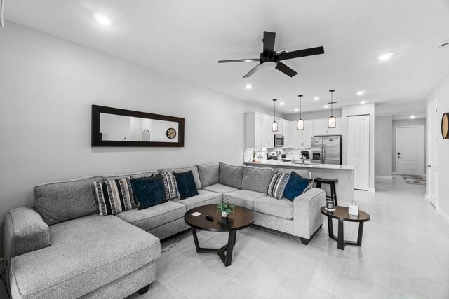 tiled living room featuring ceiling fan