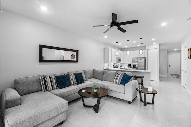 living room featuring ceiling fan, light tile patterned floors, baseboards, and recessed lighting