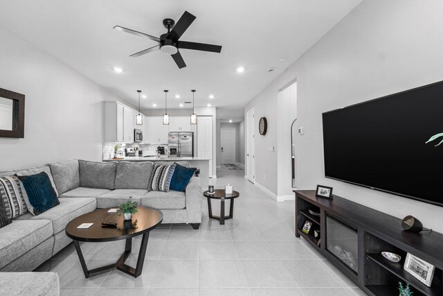 living room featuring ceiling fan and light tile patterned floors