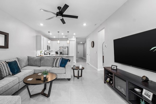 living room with ceiling fan, light tile patterned flooring, baseboards, and recessed lighting