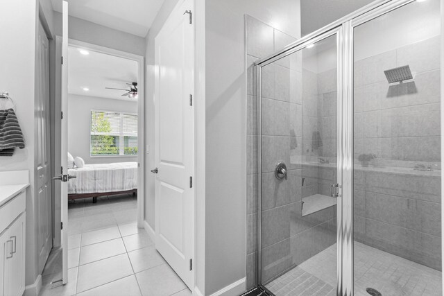 bathroom featuring walk in shower, vanity, tile patterned floors, and ceiling fan