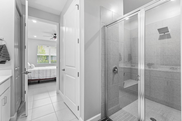 bathroom with a shower stall, connected bathroom, vanity, and tile patterned floors