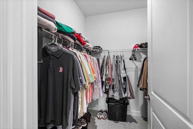 walk in closet with light tile patterned flooring