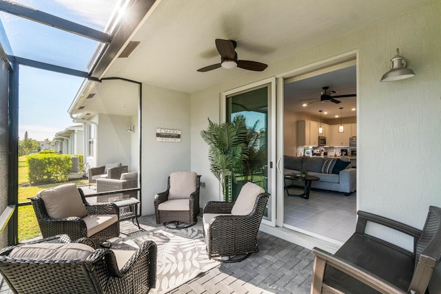 view of patio / terrace featuring glass enclosure and ceiling fan