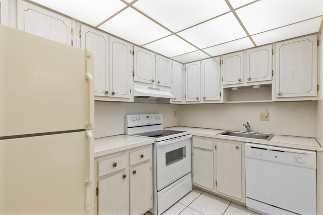 kitchen with sink, white appliances, and light tile patterned floors