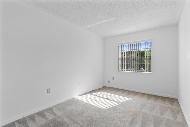 spare room with carpet floors and a textured ceiling