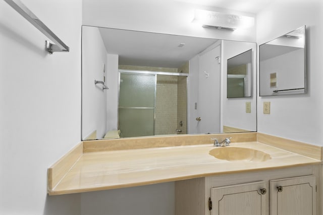 bathroom featuring an enclosed shower and vanity