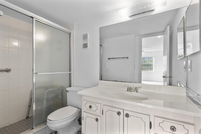 bathroom with vanity, toilet, and an enclosed shower