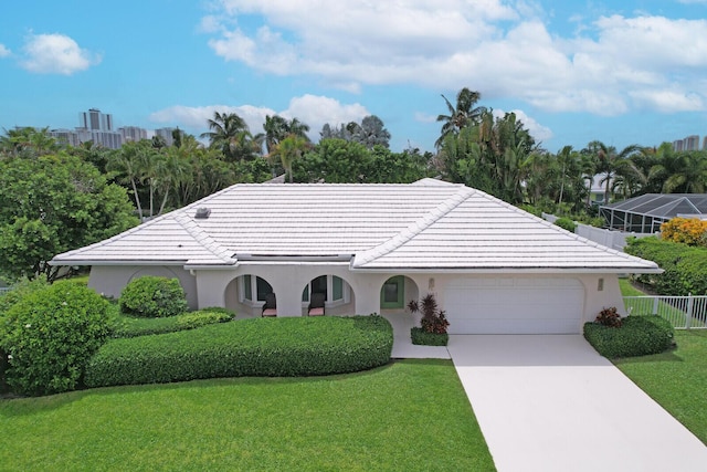 single story home featuring a front lawn and a garage