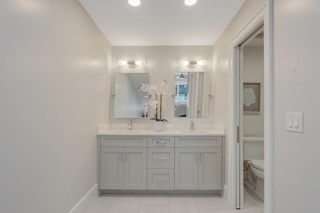 bathroom featuring tile patterned flooring, vanity, and toilet