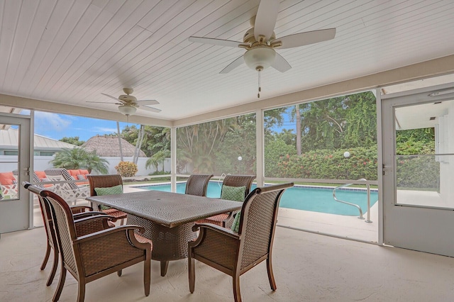 sunroom featuring ceiling fan and plenty of natural light