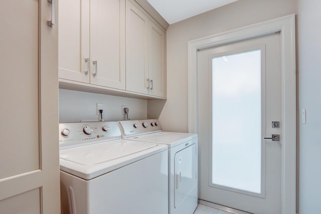 washroom featuring washer and clothes dryer and cabinets