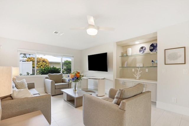 living room with ceiling fan and built in features