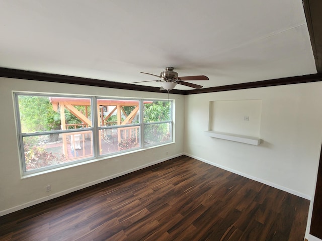 spare room featuring dark hardwood / wood-style floors, ceiling fan, and ornamental molding