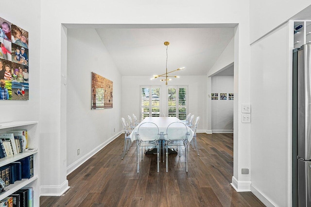 dining space with a chandelier, dark wood-type flooring, and lofted ceiling