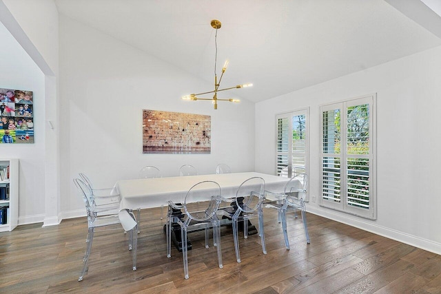 dining space featuring a chandelier, dark wood-type flooring, and lofted ceiling