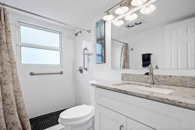 bathroom with a shower with curtain, vanity, and toilet