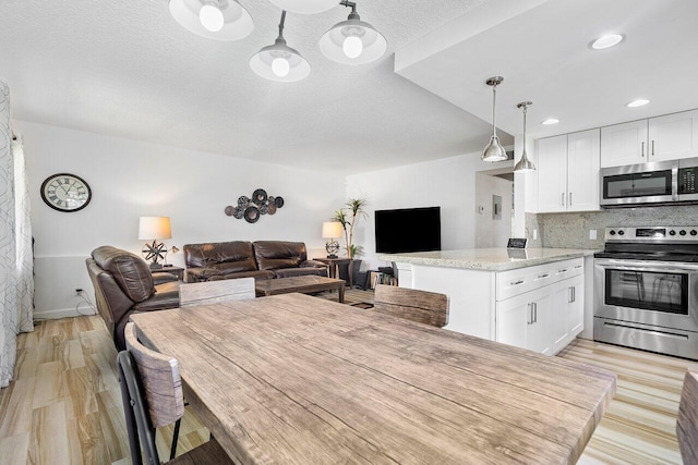 interior space featuring a textured ceiling and light hardwood / wood-style flooring