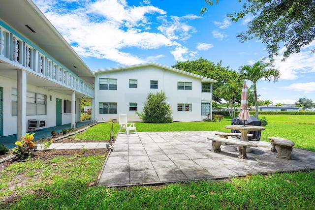 surrounding community with a lawn and a patio area