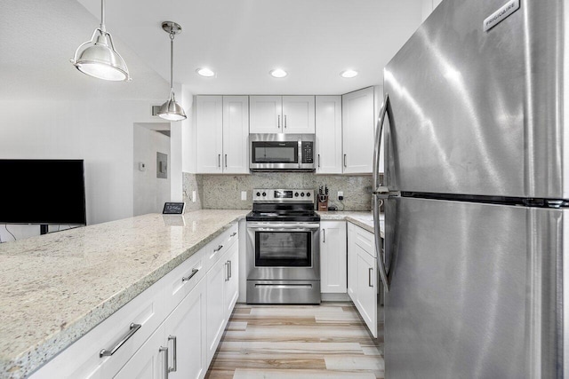 kitchen featuring decorative backsplash, light stone countertops, stainless steel appliances, pendant lighting, and white cabinetry