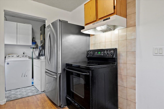 kitchen featuring light wood-type flooring, a textured ceiling, washer and clothes dryer, white cabinetry, and black / electric stove