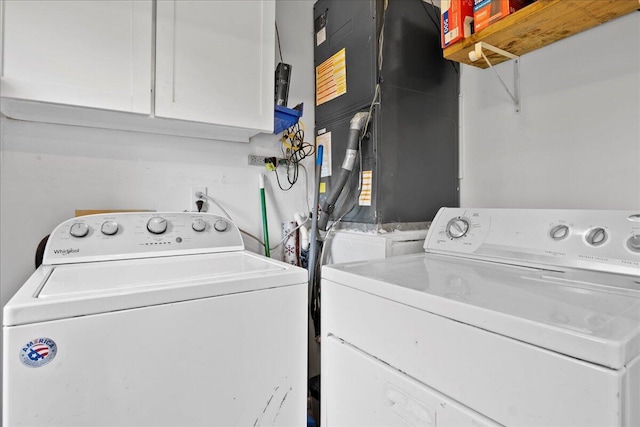 washroom featuring cabinets and separate washer and dryer