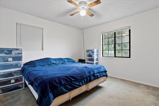 bedroom with carpet flooring, a textured ceiling, and ceiling fan