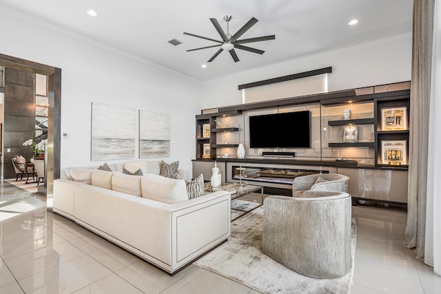 living room with ceiling fan, light tile patterned floors, and ornamental molding