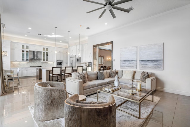 living room with ceiling fan, light tile patterned floors, and ornamental molding