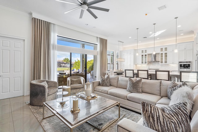 tiled living room with ceiling fan