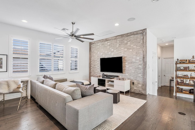 living room featuring ceiling fan, plenty of natural light, and dark hardwood / wood-style floors