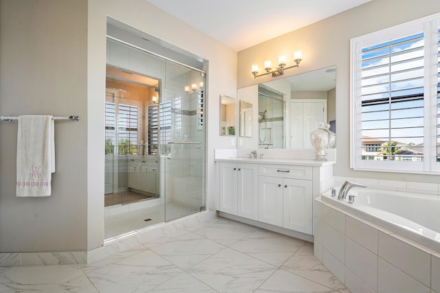 bathroom with vanity, plus walk in shower, and a wealth of natural light