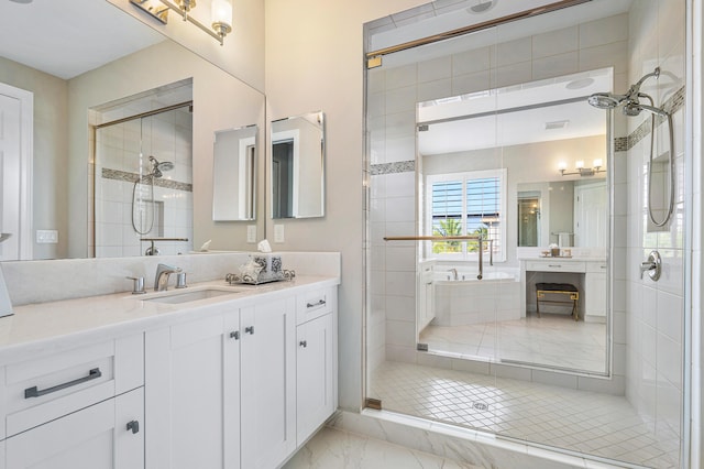 bathroom featuring vanity and shower with separate bathtub