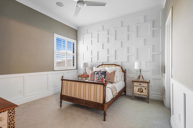 bedroom featuring light colored carpet, ceiling fan, and crown molding