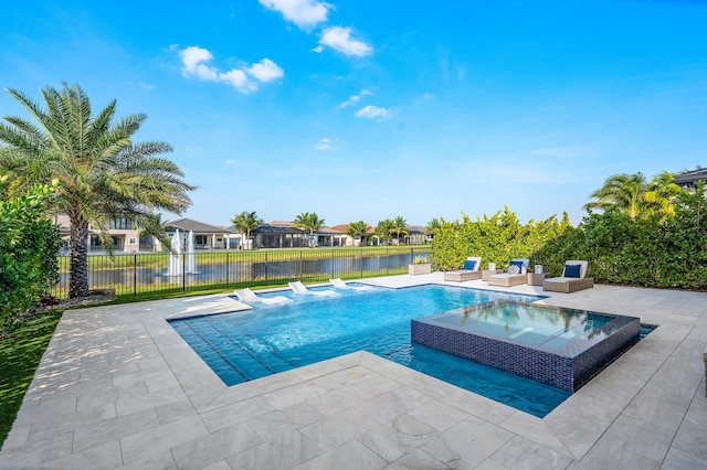 view of pool with a patio area, a water view, and an in ground hot tub