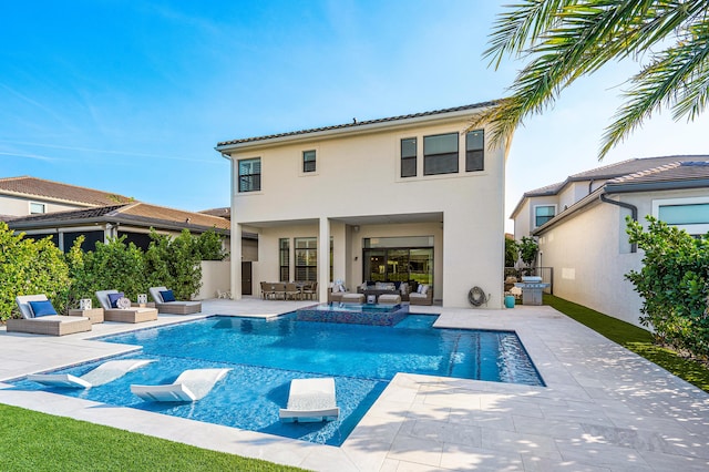 rear view of property with an outdoor living space and a patio