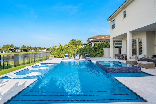 view of pool with an in ground hot tub, a patio, and a water view