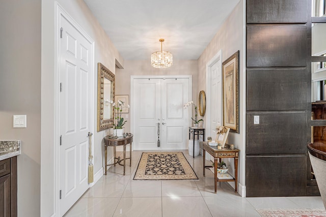 foyer entrance featuring a notable chandelier and light tile patterned floors