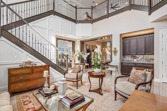 tiled living room featuring a towering ceiling