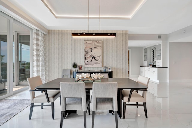 dining space with a tray ceiling