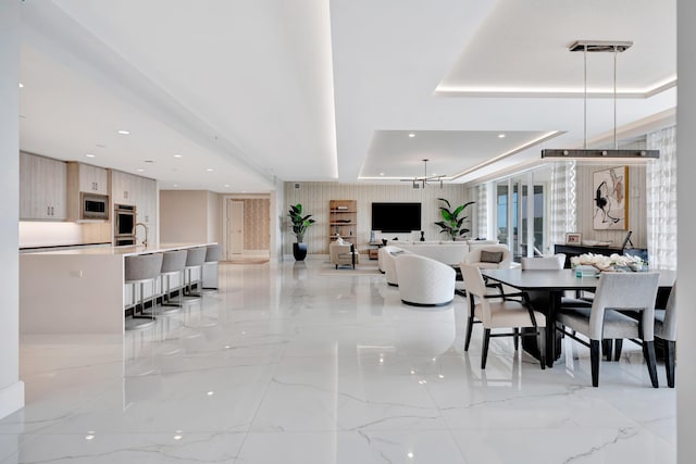 dining room with a raised ceiling and an inviting chandelier