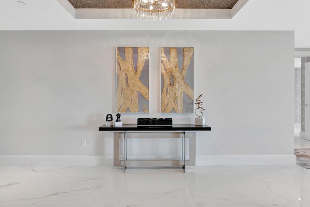 interior details with a notable chandelier and a tray ceiling