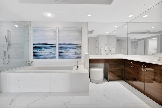 bathroom featuring shower with separate bathtub and vanity