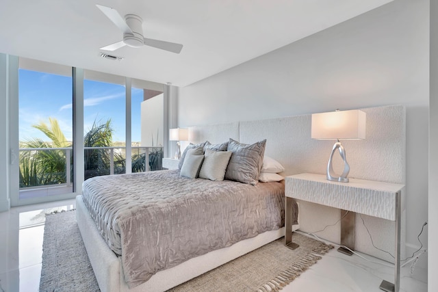 bedroom featuring ceiling fan and floor to ceiling windows