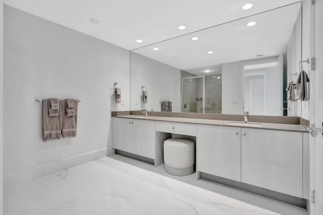 bathroom with a shower with door and vanity