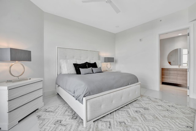 bedroom featuring ensuite bath and ceiling fan