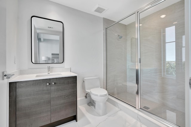 bathroom with a shower with door, vanity, and toilet