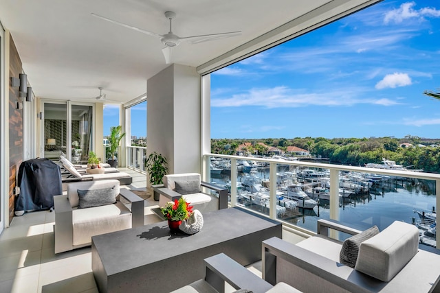 balcony with ceiling fan, a water view, a grill, and an outdoor living space