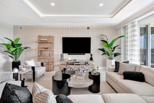 living room featuring a tray ceiling